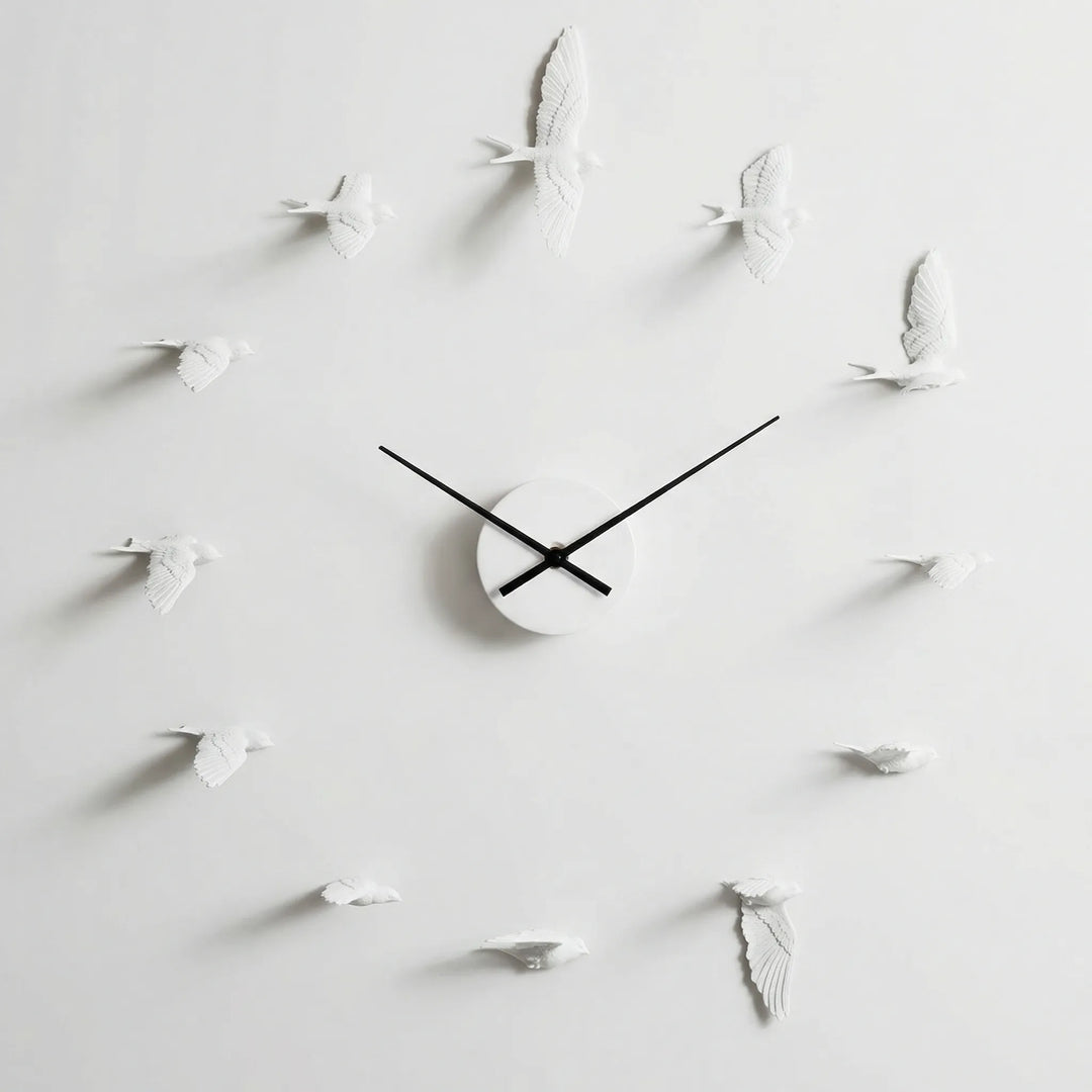 Elegant nature-themed wall clock featuring silhouette birds. A modern decorative accent for living rooms & home offices.