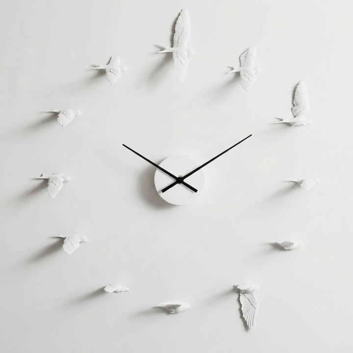 Elegant nature-themed wall clock featuring silhouette birds. A modern decorative accent for living rooms & home offices.