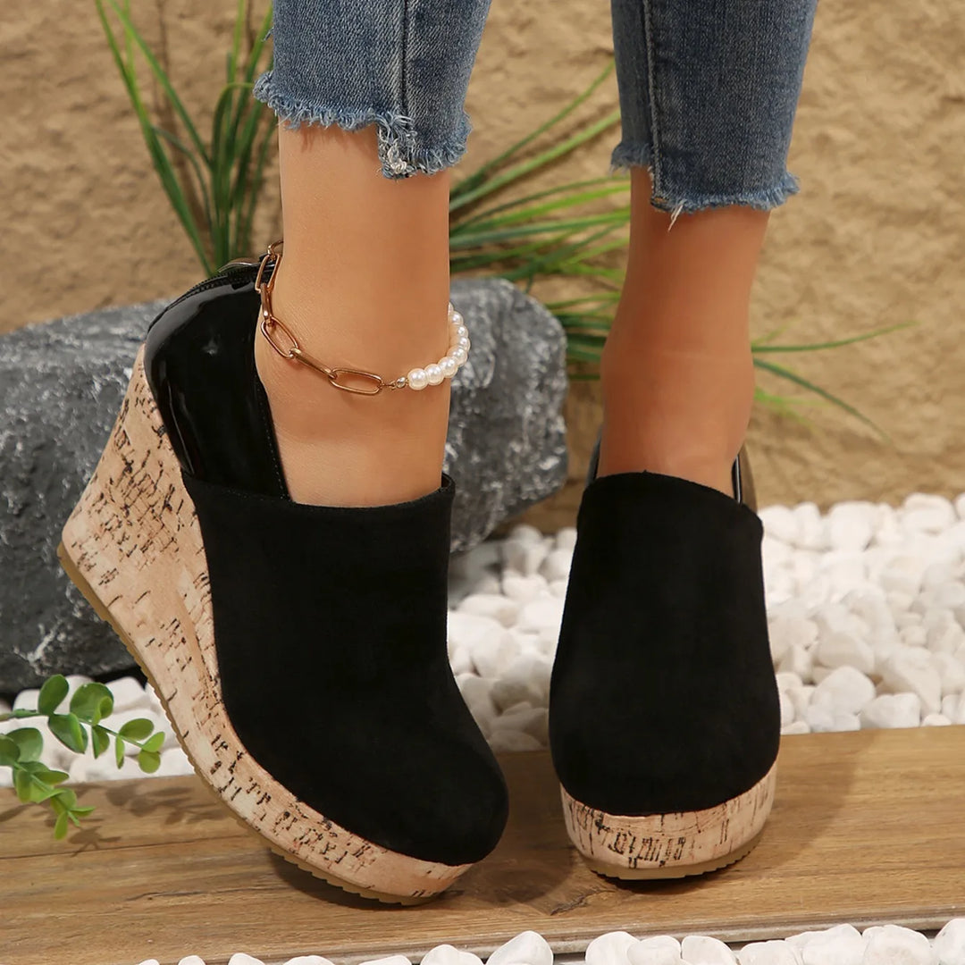 Top-down view of women's deep black slip-on wedge loafers, emphasizing orthopedic design
