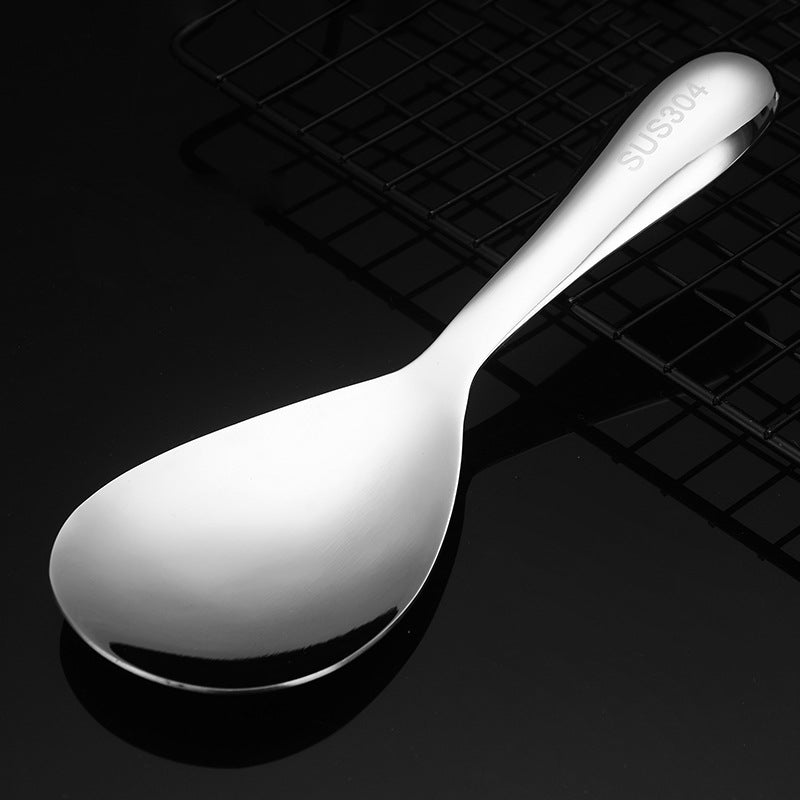 Detailed view of a non-stick stainless steel rice serving spoon, robust kitchen utensil