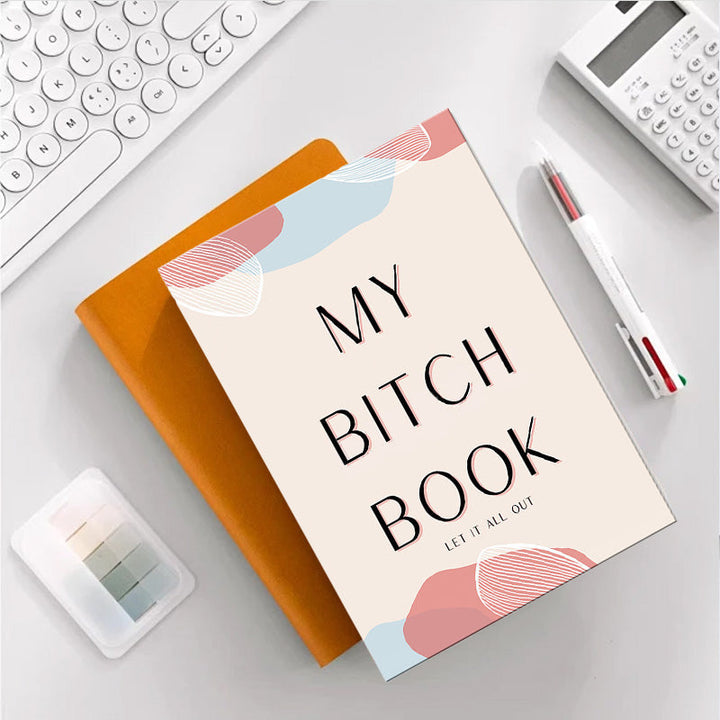 Person writing in an adult stress relief journal, practicing gratitude and self-care