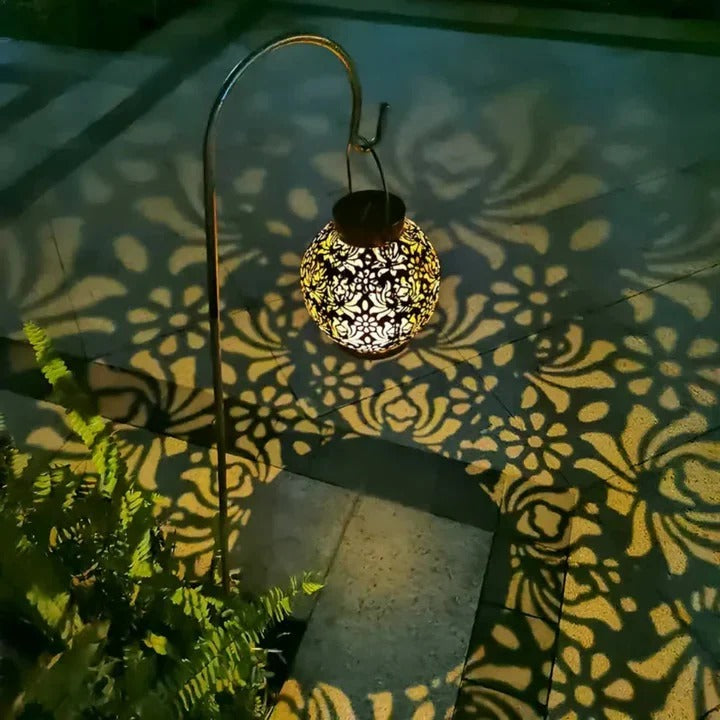 View of an outdoor LED solar pendant light, showcasing its durable construction and integrated solar panel.