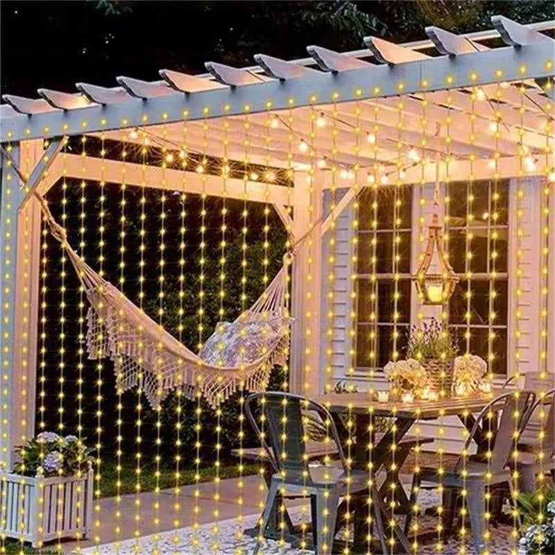 Outdoor solar curtain lights in warm white, perfect for patio decor and garden ambiance. Energy-saving LED fairy lights.
