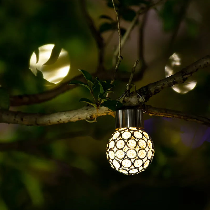 Multiple solar hanging lanterns creating a festive atmosphere for an outdoor evening event.