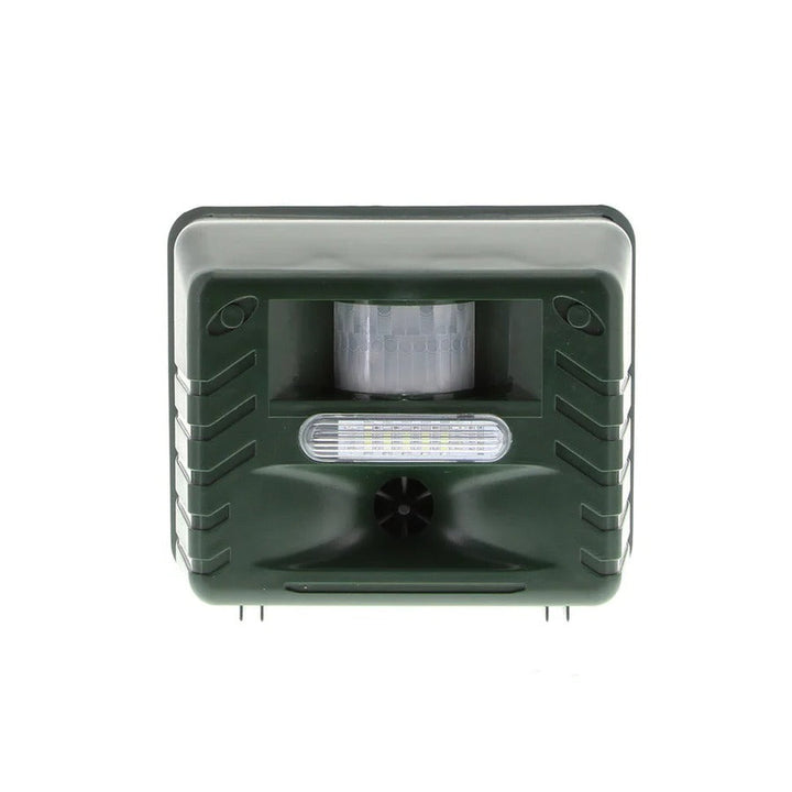 Solar outdoor bird repeller device mounted on a fence, deterring pigeons and woodpeckers from property.