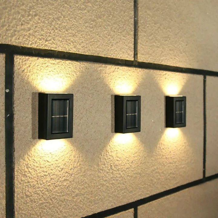 Sleek wall-mounted solar LED lamp on modern home exterior, providing security and patio lighting.