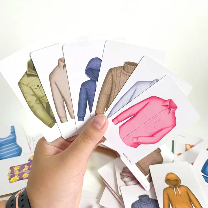 Kids and adults playing Outfitrix Family Fun Illustrated Card Game. Engaging clothing card game for creative family fun.
