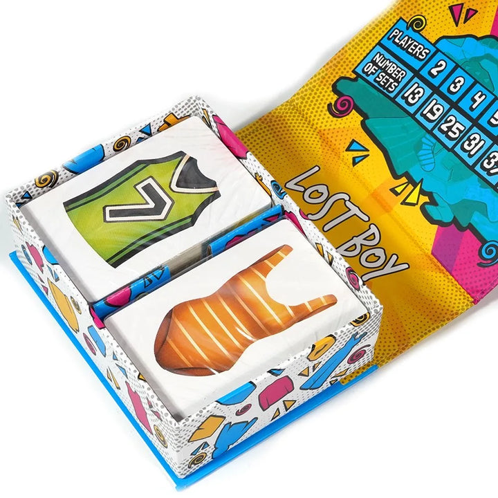 Happy kids enjoying Outfitrix Illustrated Card Game. Creative clothing game, perfect for family fun and kids' game night.