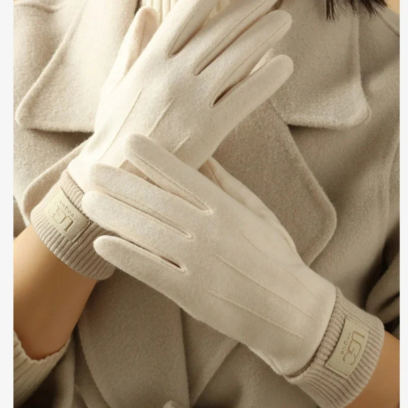 Close-up of the thumb and index finger of a cashmere touchscreen glove, showing conductive material.