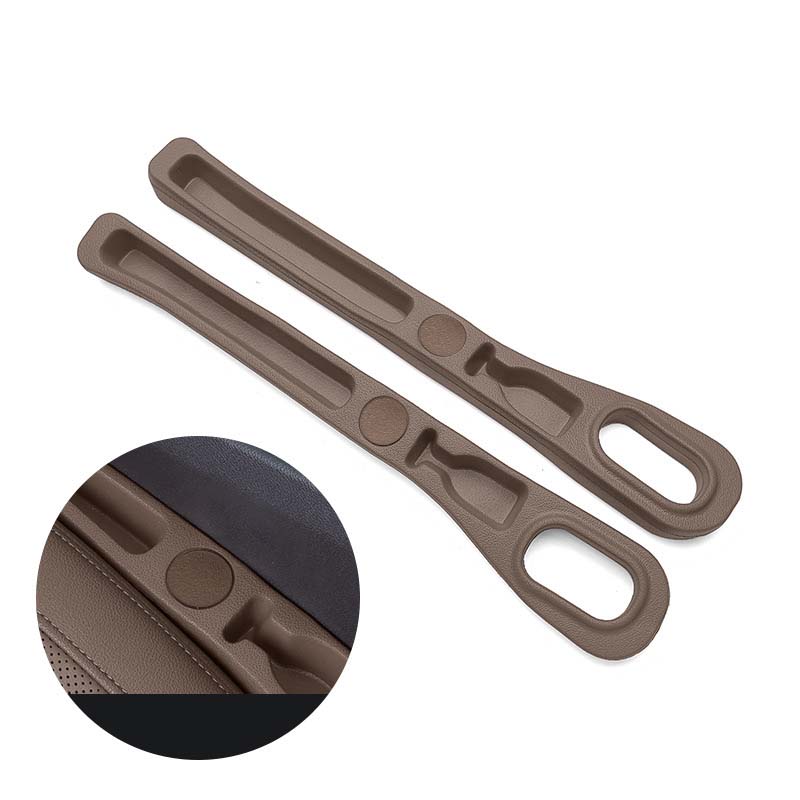 Hand placing a smartphone into the organizer pocket of the car seat gap filler.