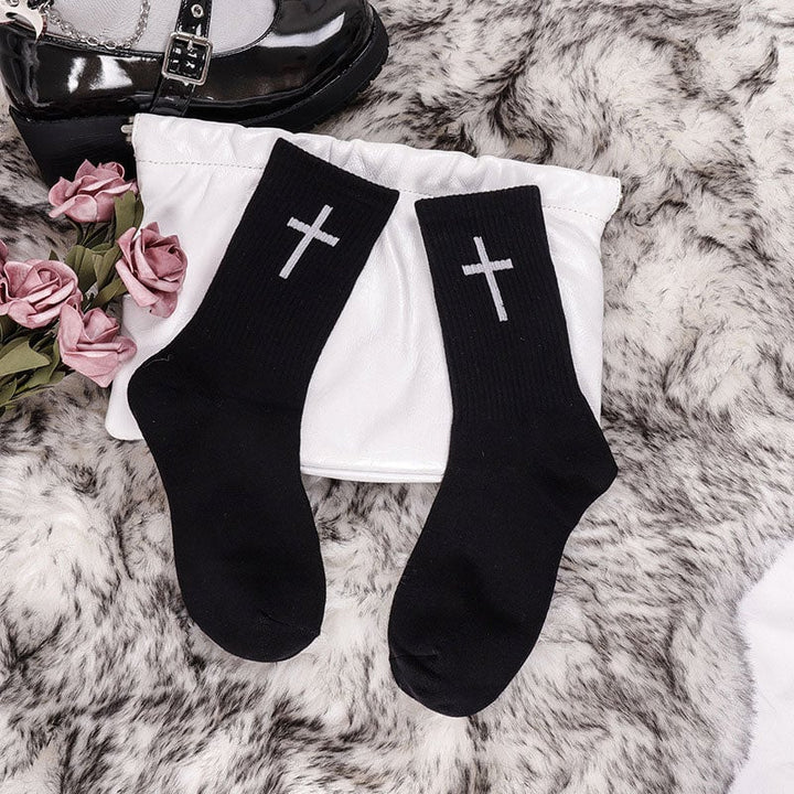 Black unisex ankle socks featuring a modern white cross design, comfortable cotton blend