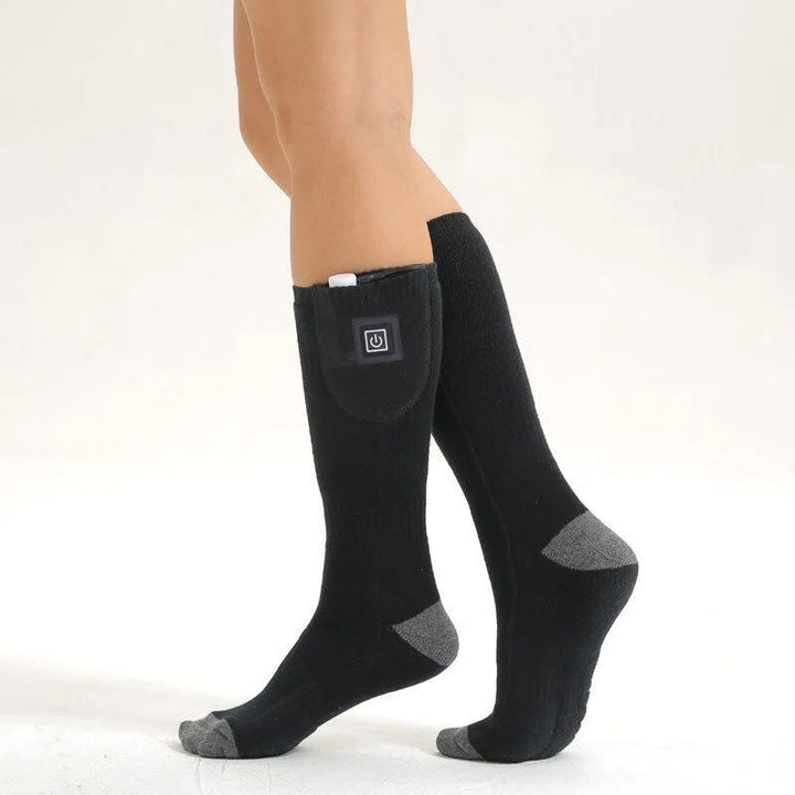 Set of unisex thermal electric socks with charger and instruction manual, complete kit.