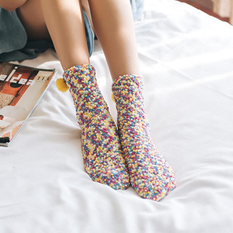 Close-up of the non-slip grip dots on the sole of a women's fluffy cupcake slipper sock.