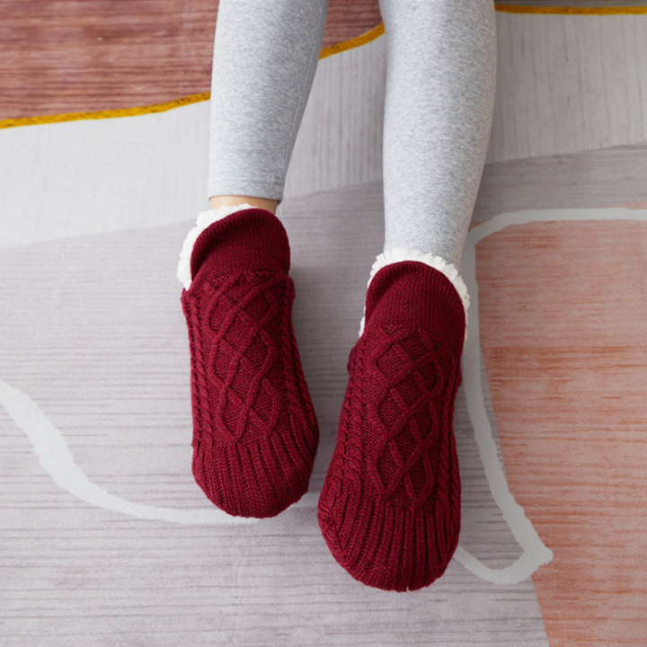 Collection of colorful fluffy unisex slipper socks, including grey and white, suitable for all genders.