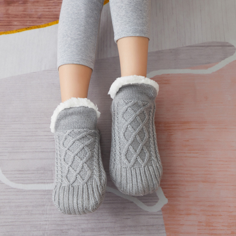 Happy feet in fluffy grey unisex slipper socks, showcasing the ultimate cozy and warm home essential.