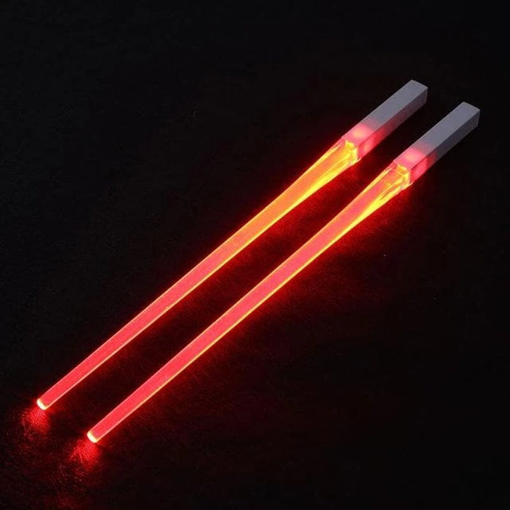 Single Lightsaber LED chopstick, red, laying on a white surface, ready to be gifted by kitchen enthusiasts.