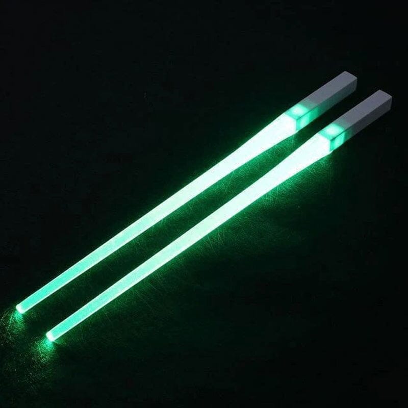 Close-up view of the luminous tip of a green Lightsaber LED chopstick, perfect for novelty dining.
