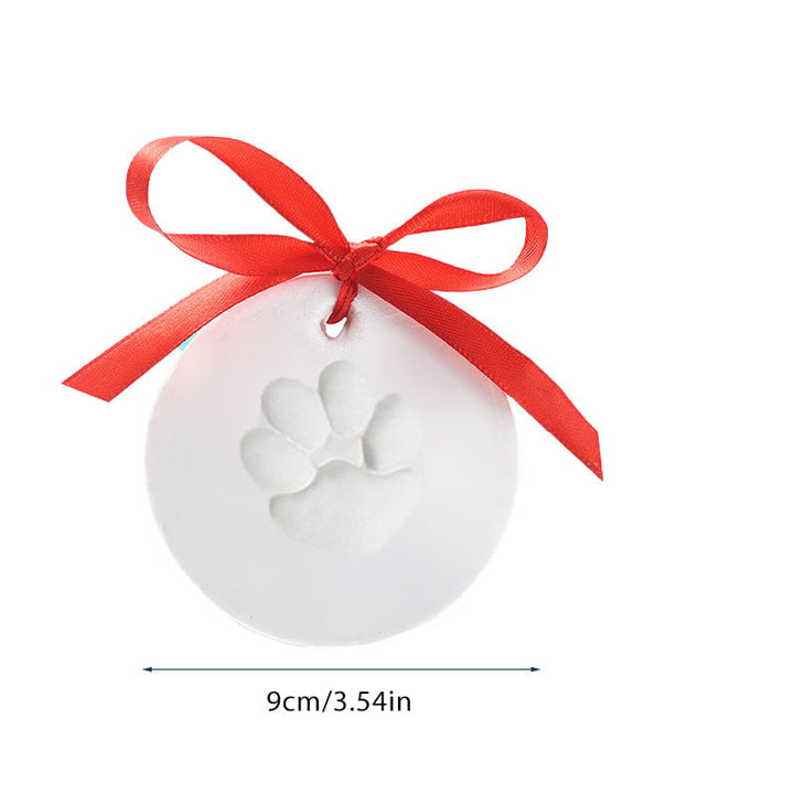 Pet paw impression kit displayed with a picture frame, suggesting a way to showcase the keepsake