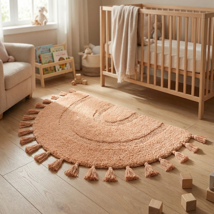 Pink half circle tassel area rug with wave pattern, ideal for entryways & nurseries. Washable & non-slip.