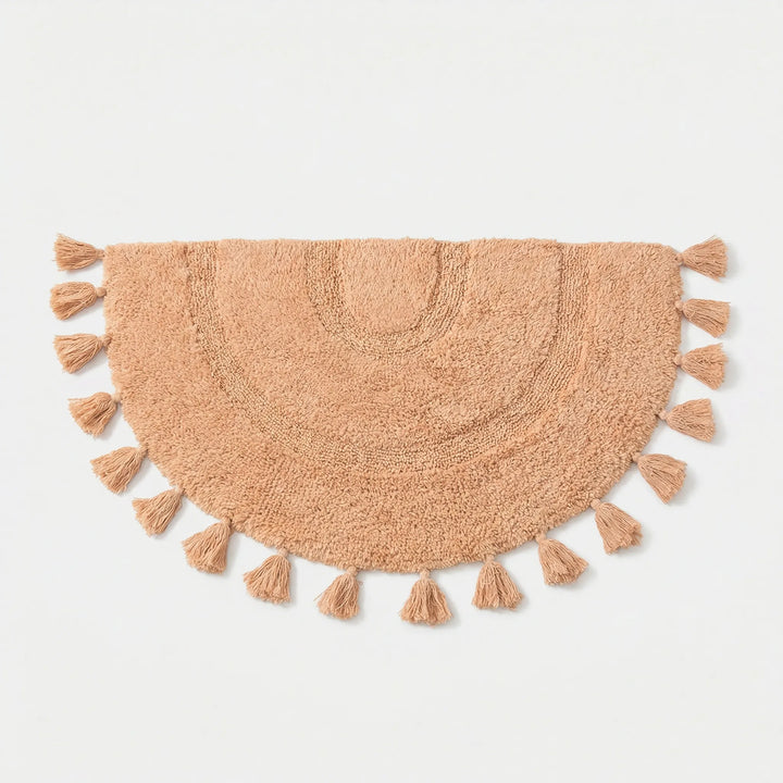 Flowique half circle accent rug in pink with playful tassels & wave design, perfect for nursery or entryway.