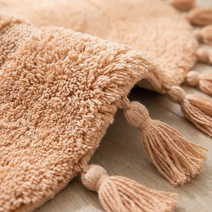 Soft pink half circle rug with elegant tassels & wave texture. Washable and non-slip for kids rooms & entryways.