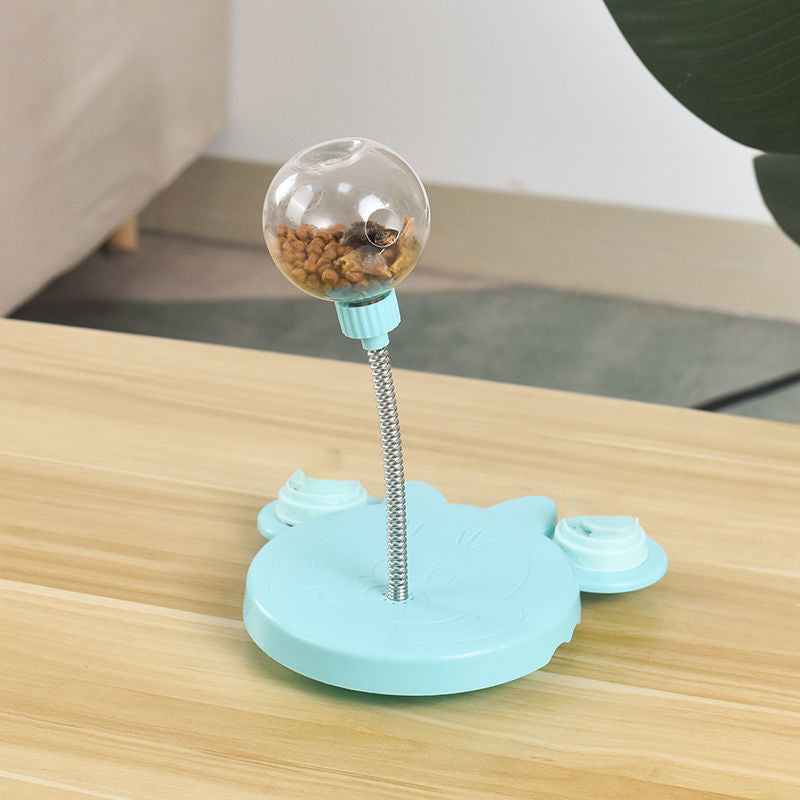 Close-up of pink pet treat dispenser toy, showing treat opening for cats