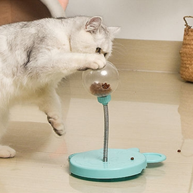 Dog paw interacting with blue puzzle feeder treat dispenser toy, slow feeder