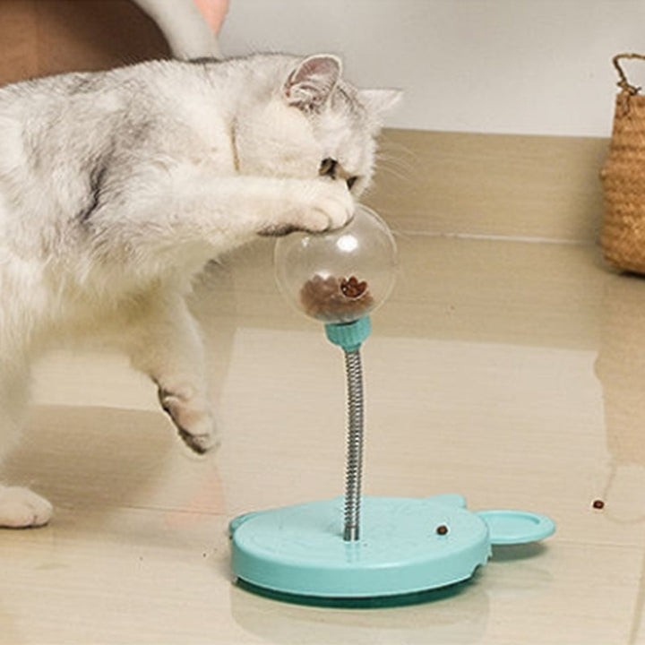 Dog paw interacting with blue puzzle feeder treat dispenser toy, slow feeder