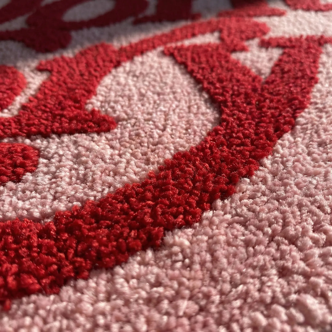 Cozy irregular pink area rug, featuring a playful wave design, perfect for modern kids' room decor.