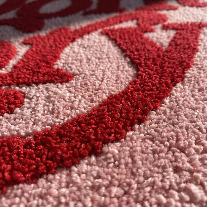 Cozy irregular pink area rug, featuring a playful wave design, perfect for modern kids' room decor.
