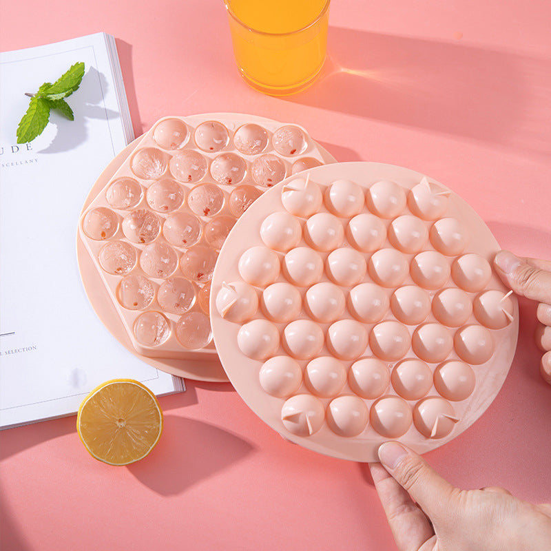 Close-up of a kitchen sphere ice mold, creating perfect ice balls for drinks.