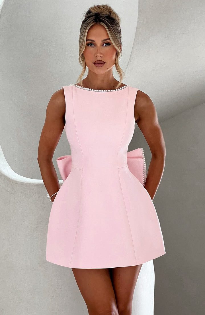 Pink structured mini dress for women, ideal for a wedding guest or cocktail party, with elegant design.