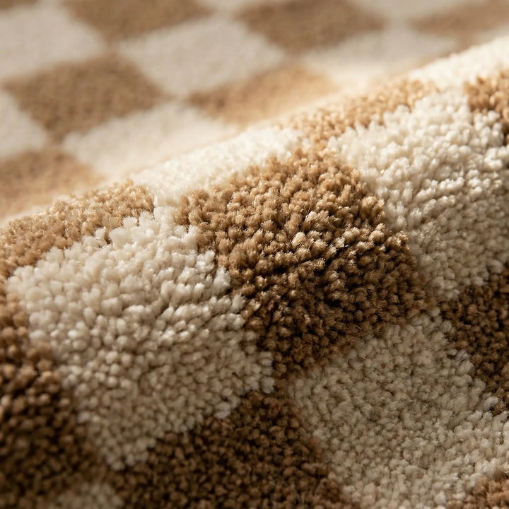Soft PlushiGrid checkered bath rug, machine washable for easy bathroom maintenance.