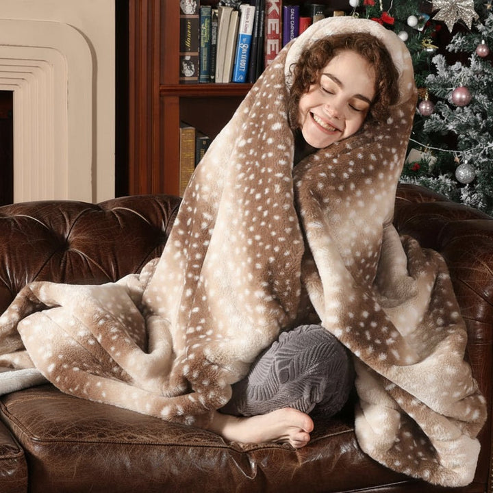 Close-up of soft plush faux fur deer blanket texture, cozy reversible throw for luxurious bedroom warmth.