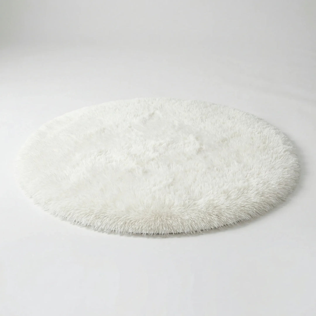 Cozy plush round area rug, featuring an elegant wave pattern. Soft accent for bedroom, living room, or home decor.