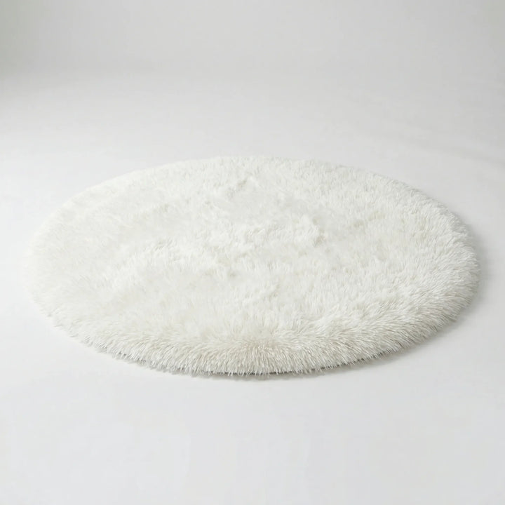 Cozy plush round area rug, featuring an elegant wave pattern. Soft accent for bedroom, living room, or home decor.