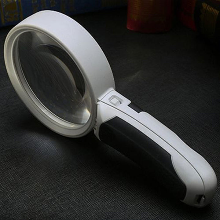 Side view of the portable 20x magnifier, showing its sturdy design and integrated LED light.
