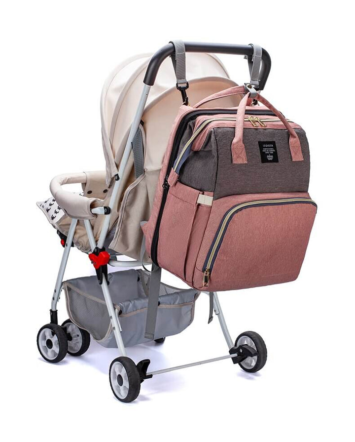 Comfortable portable baby bed unfolds from a durable travel diaper backpack for rest.