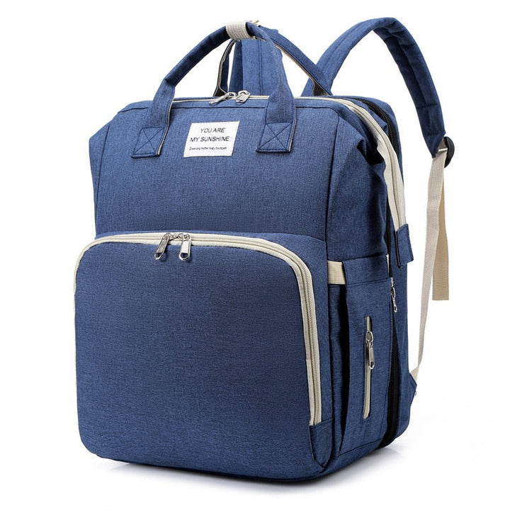 Diaper bag unfolded as a convenient changing station & portable bed for quick changes.