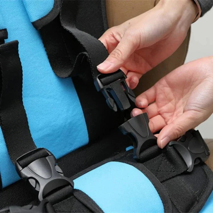 Compact taxi seat for kids, featuring a 5-point safety harness for vehicle travel.