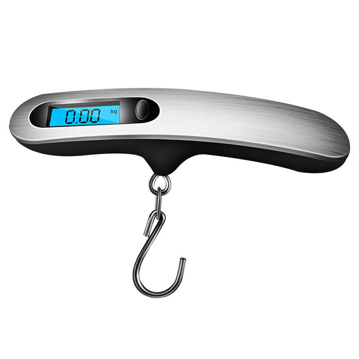 Portable luggage scale next to a suitcase, emphasizing its role as an essential travel accessory for accurate weighing