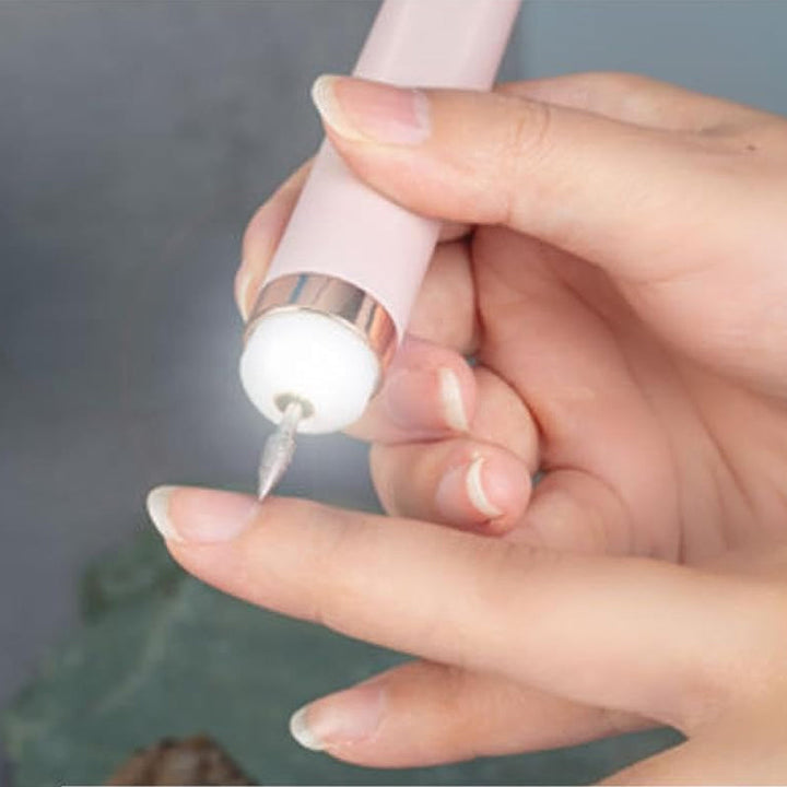 Manicure kit organized with electric nail drill, sanding bands, and cuticle tools