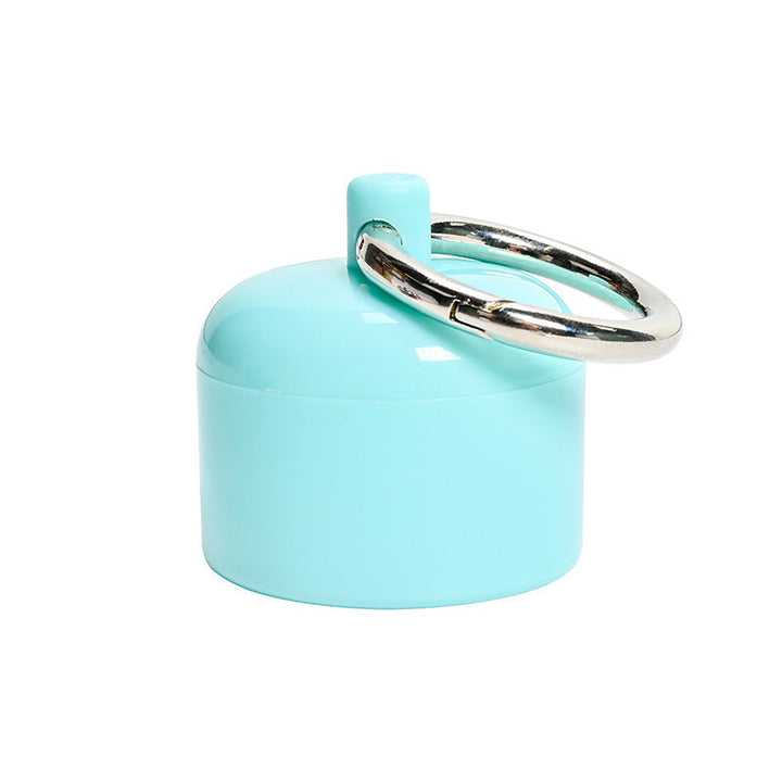 Stack of multiple colored portable keychain organizers for pills and small jewelry