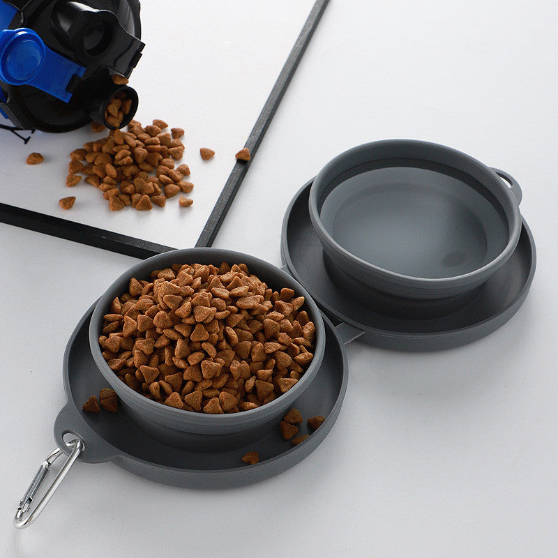 Hand holding folded blue silicone pet travel bowl set, demonstrating portability and compact size