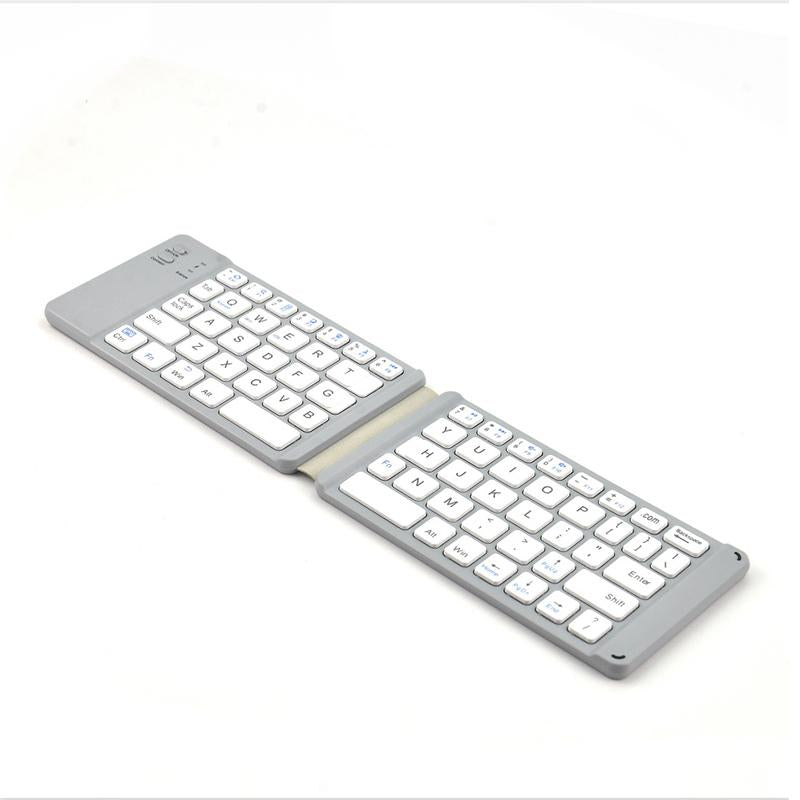 Folded portable Bluetooth keyboard with touchpad, fitting easily into a small bag or pocket