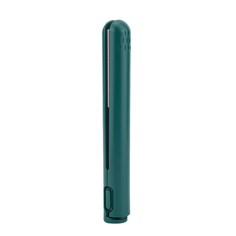 Detailed view of the power button and indicator light on the USB-powered travel hair styling tool.