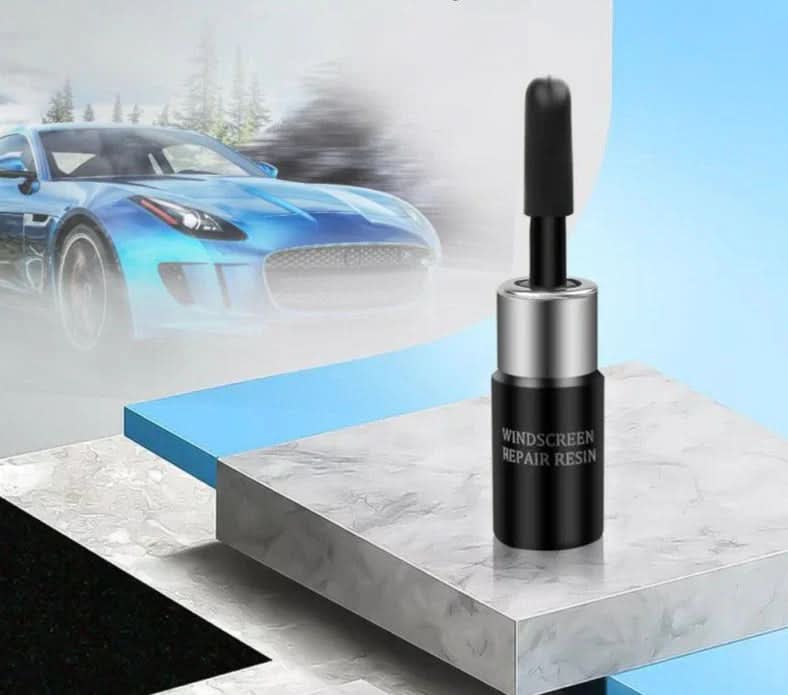 Hand applies resin from professional auto glass repair kit to fix a windshield chip. Essential DIY car maintenance.