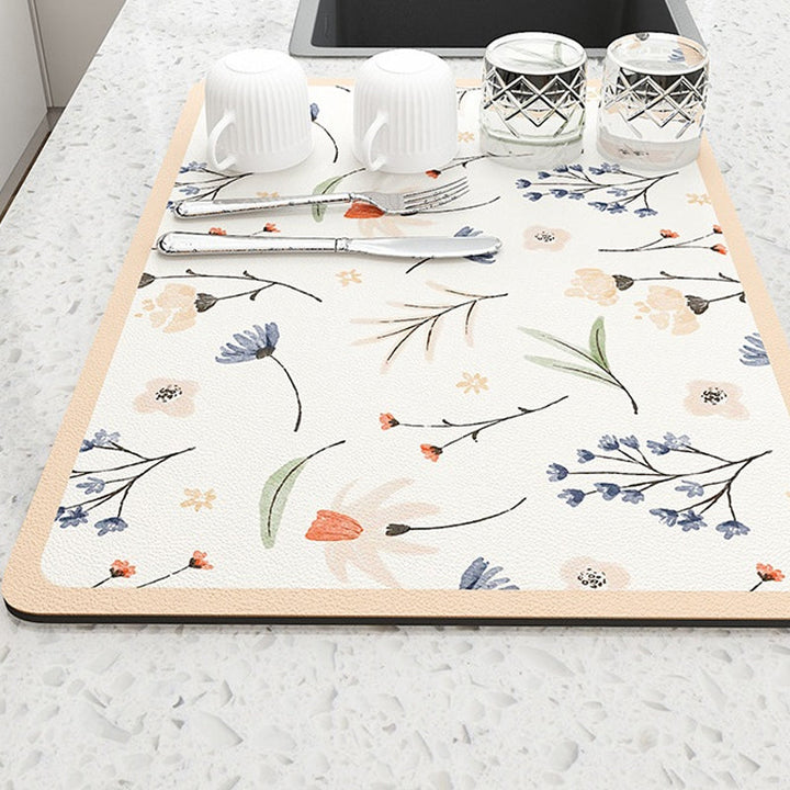 Top-down view of a textured diatomaceous earth drying mat, a stylish kitchen countertop protector.