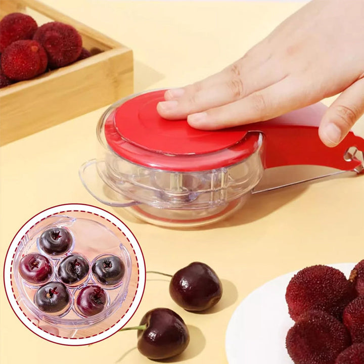 Red cherry pitter tool on a white background, showcasing its sleek and functional design.