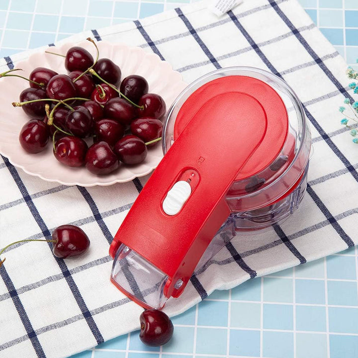 Close-up of the cherry pitter's mechanism, designed for clean and quick pit removal.